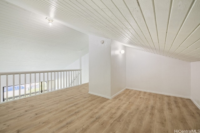 bonus room with vaulted ceiling, light hardwood / wood-style flooring, and wood ceiling