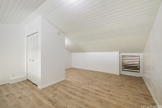 bonus room with light hardwood / wood-style floors and vaulted ceiling