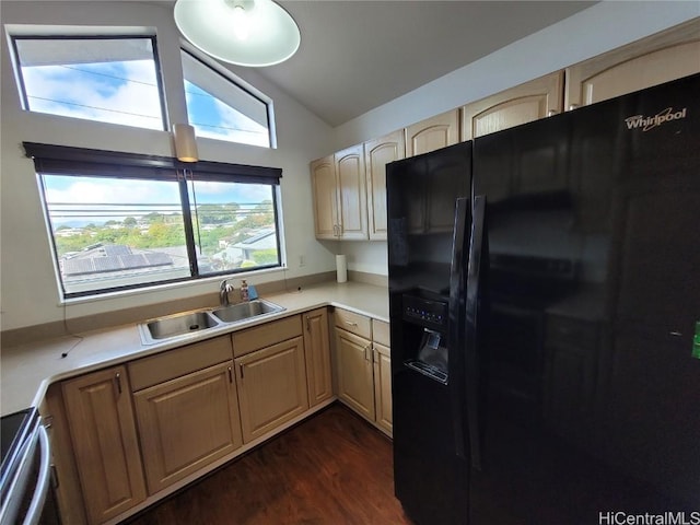 kitchen with dark wood finished floors, light countertops, black refrigerator with ice dispenser, vaulted ceiling, and a sink