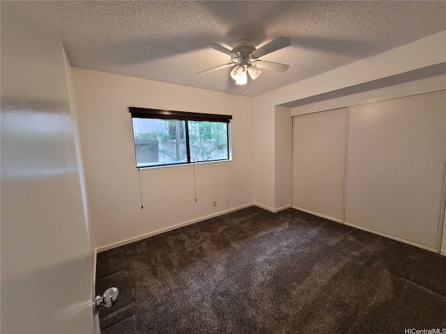 99-733 Meaala St, Aiea, HI 96701 - unfurnished bedroom featuring dark carpet, a textured ceiling, ceiling fan, baseboards, and a closet