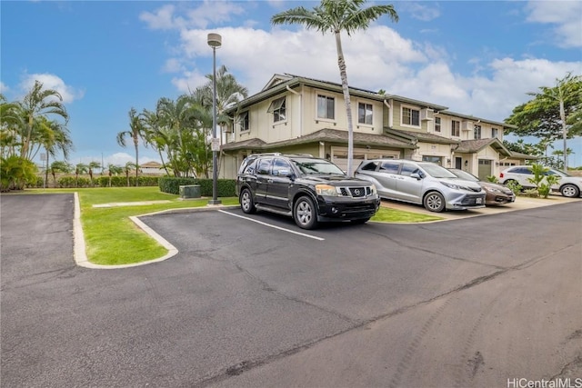 uncovered parking lot with a residential view