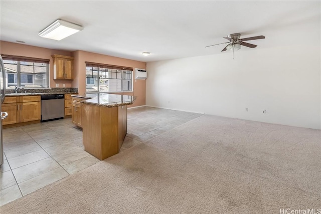 kitchen with dishwasher, light tile patterned floors, a kitchen island, and light colored carpet