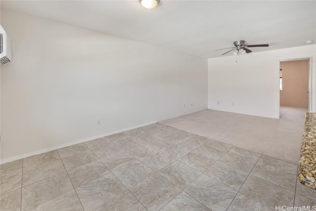 empty room featuring ceiling fan and light colored carpet