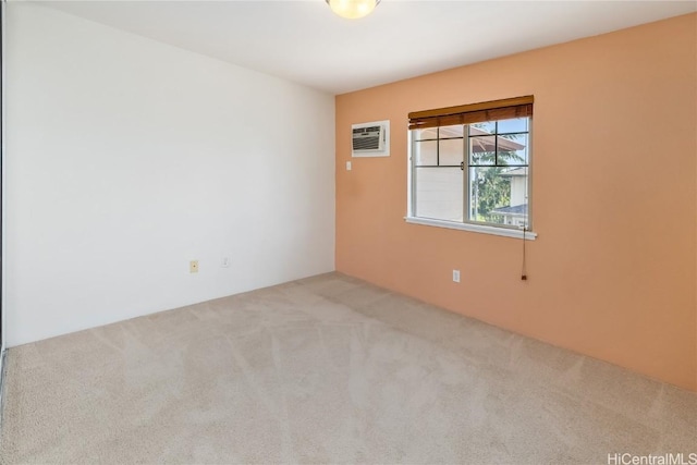 empty room featuring light carpet and a wall unit AC