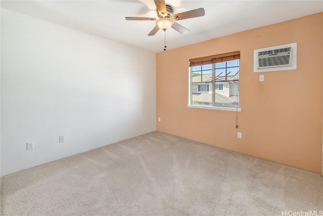 spare room featuring ceiling fan, an AC wall unit, and carpet floors