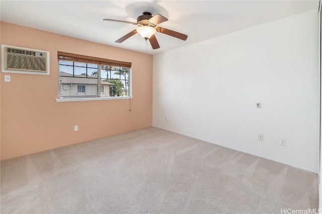 empty room with ceiling fan, an AC wall unit, and carpet