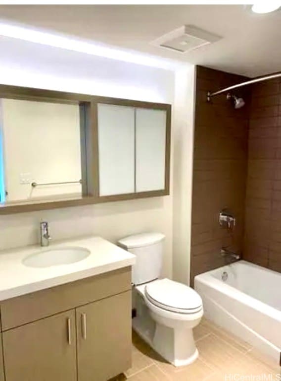 full bathroom with toilet, vanity, tiled shower / bath, and tile patterned flooring