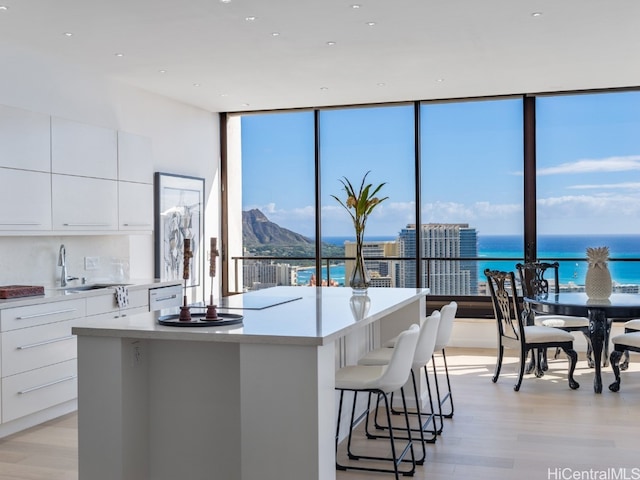 kitchen featuring white cabinets, a water view, and a kitchen island