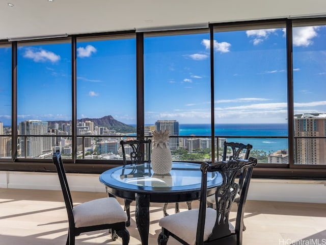 sunroom / solarium featuring a water view