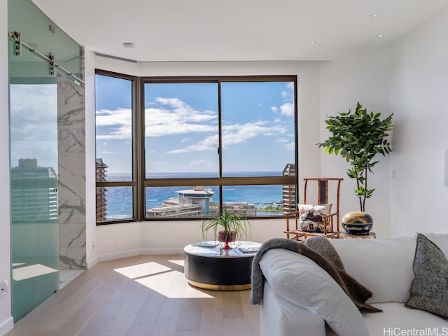 bedroom with a water view and hardwood / wood-style flooring