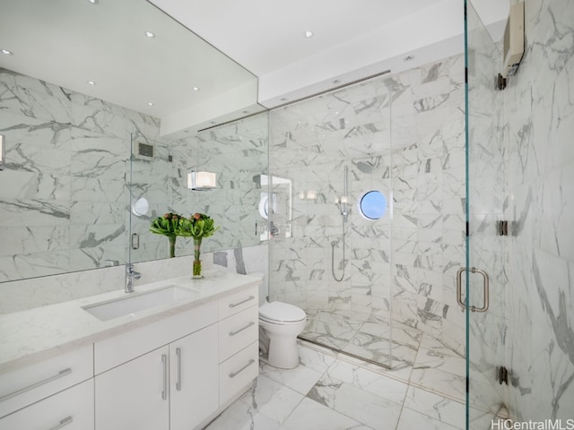 bathroom featuring vanity, a shower with shower door, tile walls, and toilet