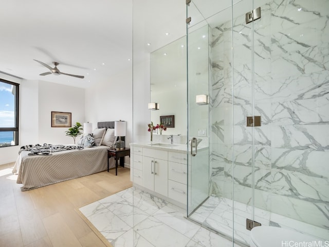 bathroom featuring hardwood / wood-style floors, vanity, ceiling fan, and a shower with shower door