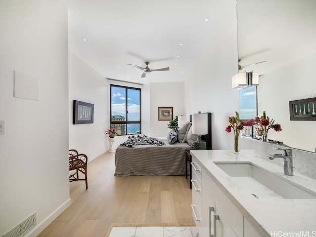 bedroom with light hardwood / wood-style floors and sink