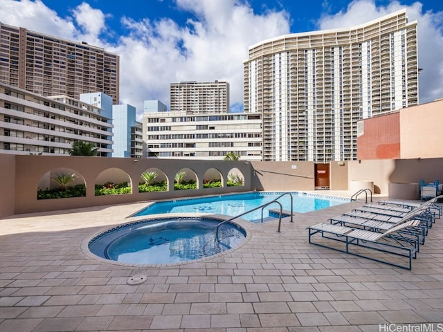 view of pool featuring a patio and a hot tub