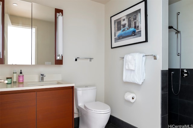 bathroom featuring walk in shower, vanity, and toilet