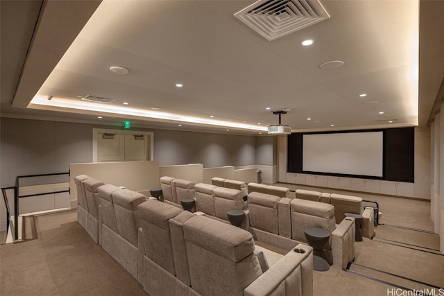 carpeted cinema with a raised ceiling