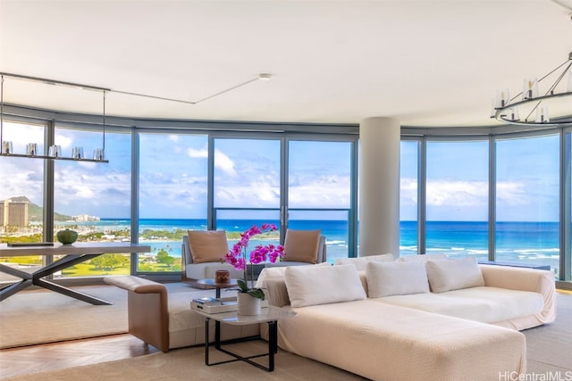 living room with a wall of windows, a water view, and parquet floors