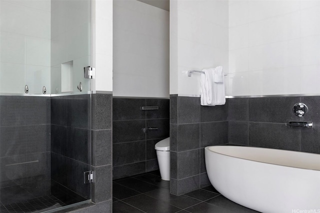 1108 Auahi St Unit 1300, Honolulu, HI 96814 - full bathroom featuring tile walls, a freestanding tub, a stall shower, tile patterned floors, and a wainscoted wall