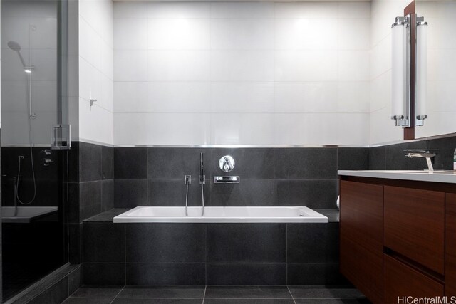 bathroom with vanity, tile patterned flooring, separate shower and tub, and tile walls