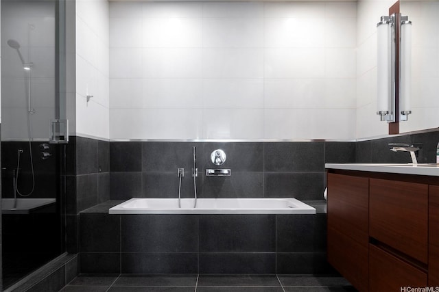 1108 Auahi St Unit 1300, Honolulu, HI 96814 - bathroom featuring vanity, a garden tub, a stall shower, and tile walls