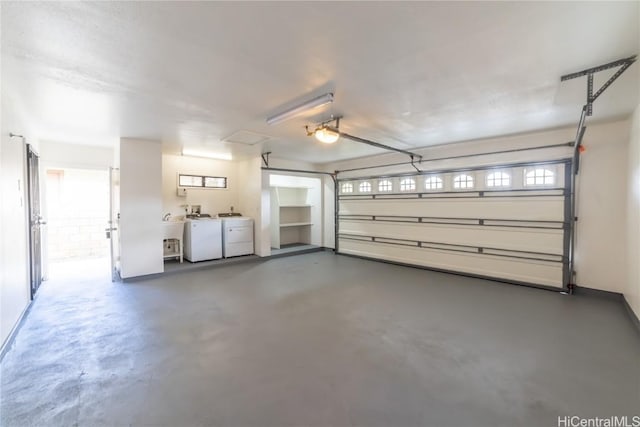 garage with a garage door opener and washer and clothes dryer