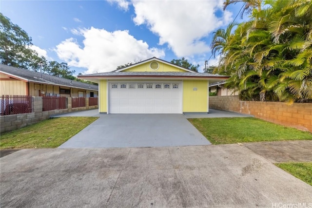 ranch-style house with a garage and a front lawn