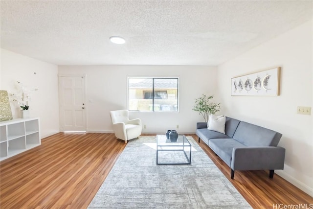 living room featuring hardwood / wood-style flooring and a textured ceiling