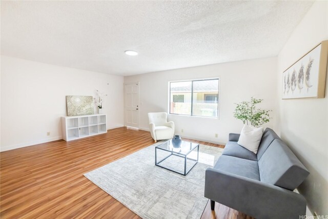 83 Iho Iho Pl, Wahiawa, HI 96786 - living area featuring wood finished floors and a textured ceiling
