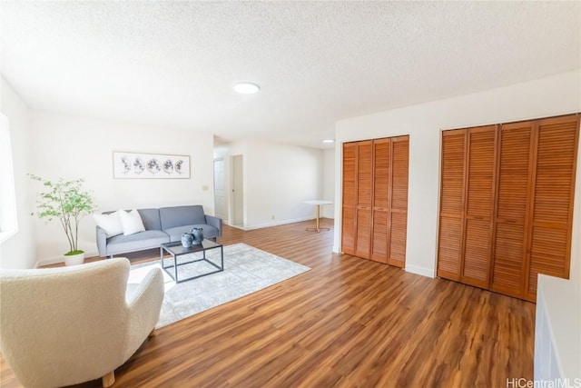 living room with hardwood / wood-style floors and a textured ceiling