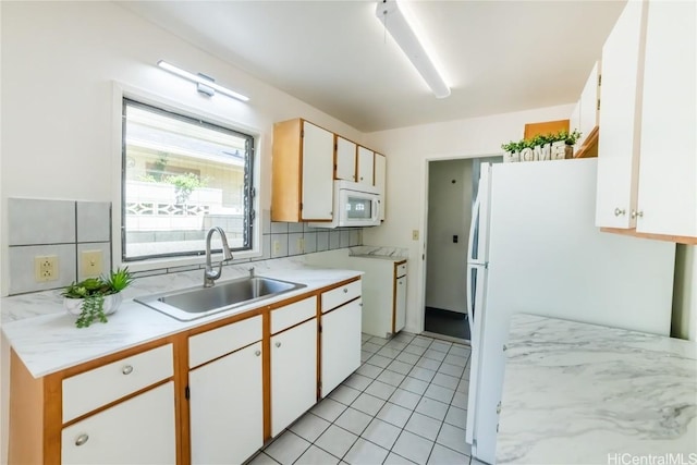 kitchen featuring backsplash, sink, white cabinets, and white appliances