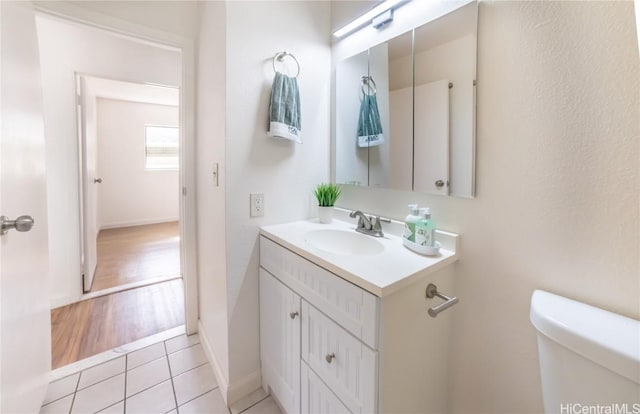 bathroom featuring toilet, vanity, and tile patterned floors