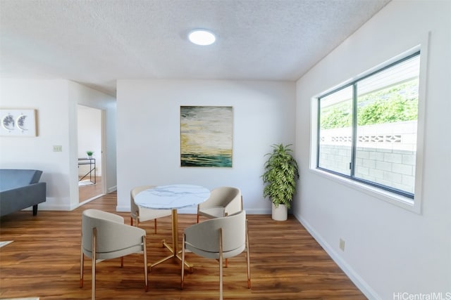 living area featuring dark hardwood / wood-style floors and a textured ceiling