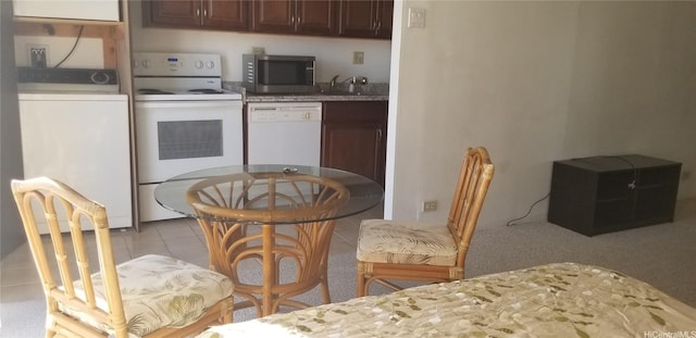 1630 Liholiho St Unit 2205, Honolulu, HI 96822 - kitchen with white appliances, washer / dryer, light tile patterned flooring, and light countertops