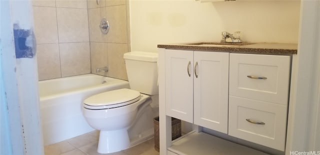 full bathroom featuring tile patterned floors, vanity, tiled shower / bath combo, and toilet