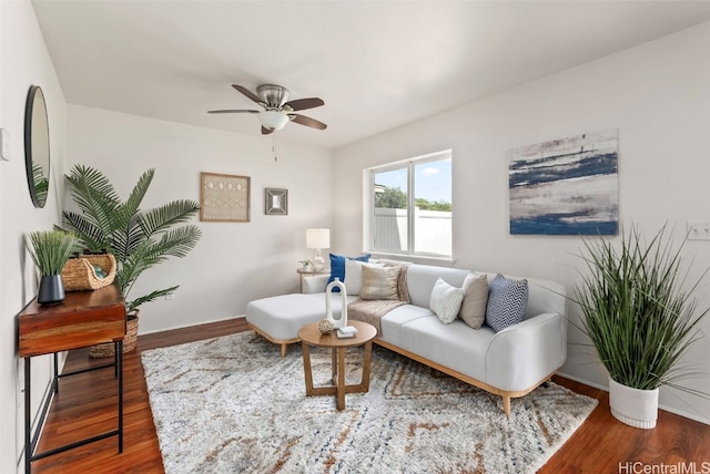 living room featuring wood-type flooring and ceiling fan