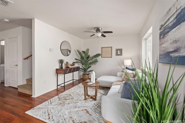 living room featuring dark hardwood / wood-style floors and ceiling fan