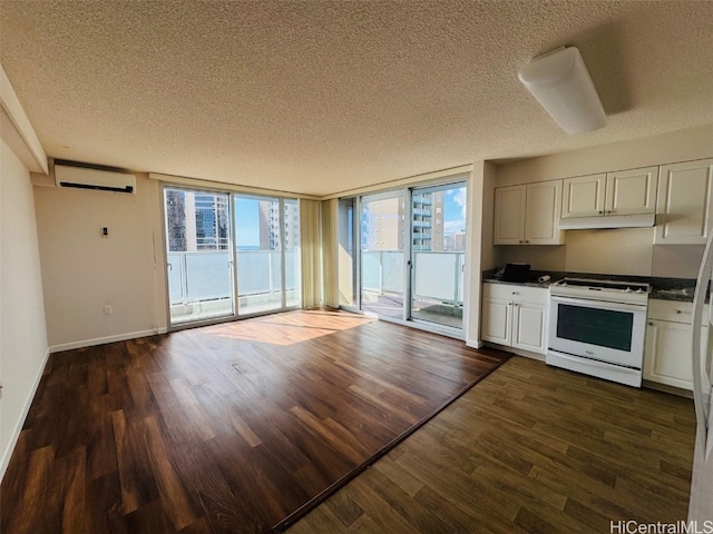 kitchen with a textured ceiling, white range, and dark hardwood / wood-style flooring