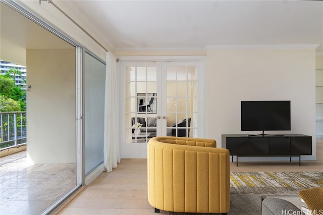 living room featuring french doors, light wood-type flooring, and crown molding