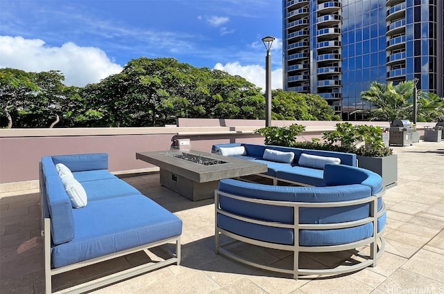 view of patio / terrace featuring a grill and an outdoor living space with a fire pit