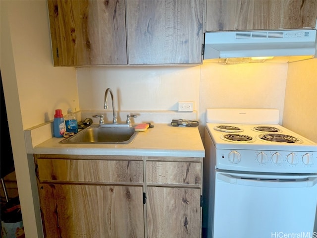 kitchen featuring white electric range oven, light brown cabinetry, sink, and exhaust hood