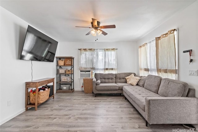 living room featuring ceiling fan, light hardwood / wood-style flooring, and cooling unit