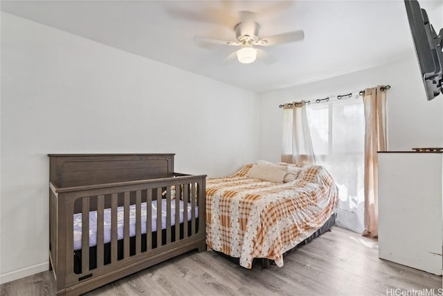 bedroom featuring ceiling fan and light hardwood / wood-style flooring