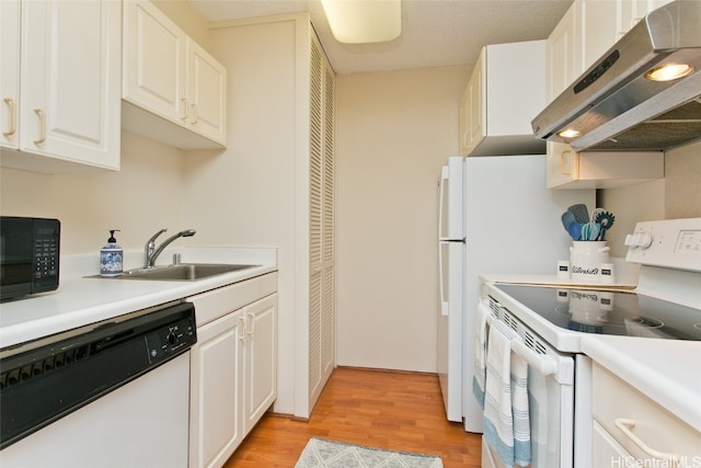 kitchen featuring white appliances, white cabinets, sink, light hardwood / wood-style floors, and extractor fan