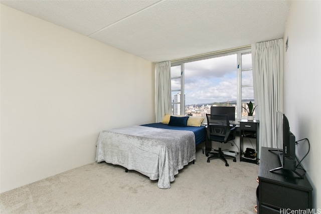 carpeted bedroom featuring a textured ceiling