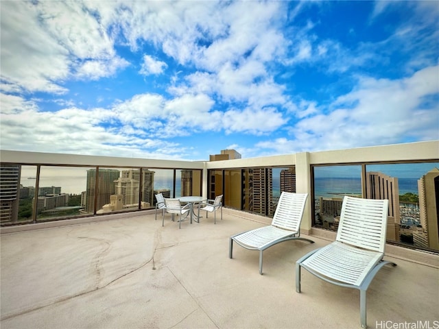 view of patio / terrace with a water view and a balcony