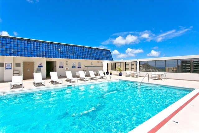 view of swimming pool featuring a patio area