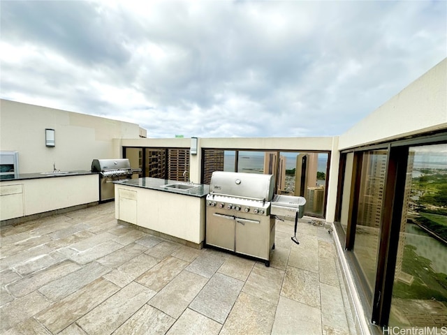 view of patio / terrace featuring area for grilling, exterior kitchen, and sink