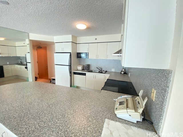 kitchen with sink, ventilation hood, kitchen peninsula, white cabinets, and black appliances