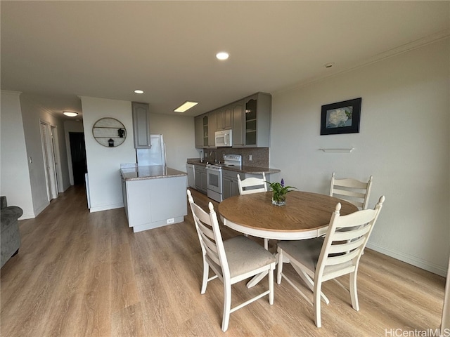 dining space with light hardwood / wood-style flooring