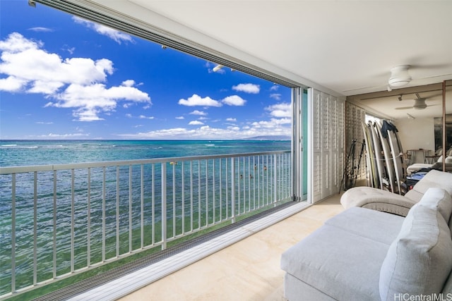 balcony with ceiling fan, a water view, and an outdoor hangout area